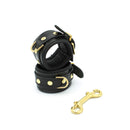 Kiotos Leather - Lederen Polsboeien Met Goudkleurige Metalen Hardware - Zwart-Erotiekvoordeel.nl